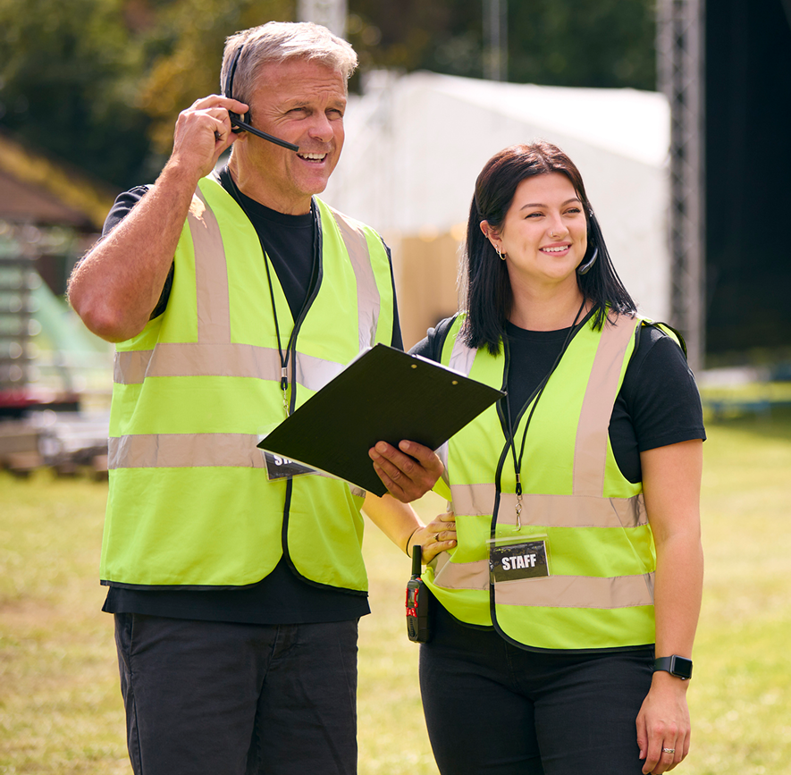 Event staff coordinating with headsets and clipboard.